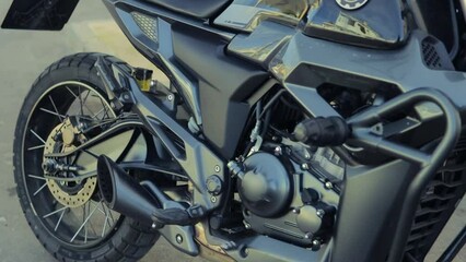 Close up of a stylish vintage motorcycle. Motorcycle engine, wheel and other parts close up.