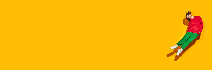 A stylish jump shot, featuring young woman in fashionable activewear against vivid yellow background, symbolizing synergy of style and motion. Concept of fashion and beauty, shopping, sales. ad