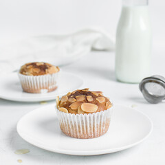 almond muffins on a white plate, homemade bakery style almond muffins on a white background