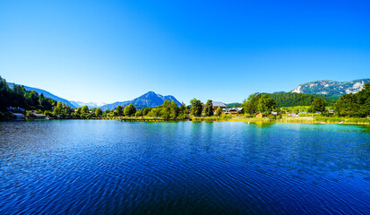 Landscape at Lake Altaussee in the Salzkammergut in Austria. Idyllic nature by the lake in Styria. Altaussee at Totes Gebirge with a view of the surrounding mountains.

