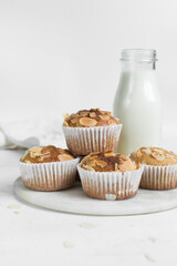 vanilla almond muffins on a white marble tray, homemade bakery style almond muffins on a white background	