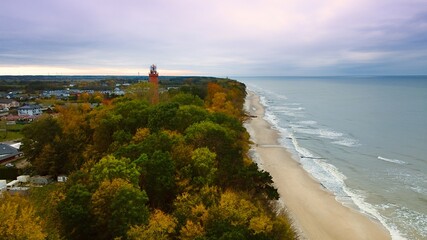 Captured by drone on a cloudy November day, the Gąski lighthouse stands against the somber sky....