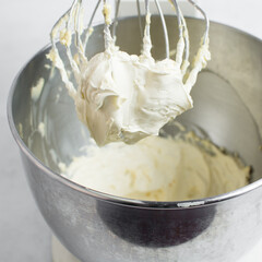 Cream colored american buttercream on a whisk attachment, russian buttercream on a whisk