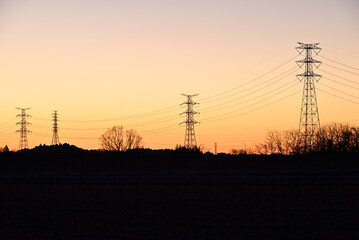 Fototapeta na wymiar Towers of power line in magic hour 