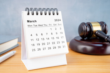 Desk calendar for March 2024 and judge's gavel.