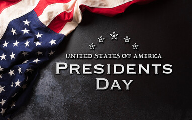 Happy Presidents day concept made from American flag and the text on dark stone background.