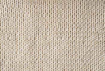 Beige knitted texture made of cotton thread.