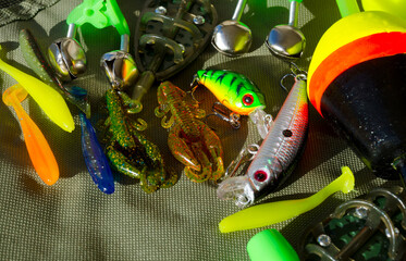 Fishing gear on a tarpaulin background.