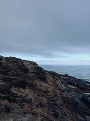 Rocks at the ocean coast, ocean bay, rocks, gray sky
