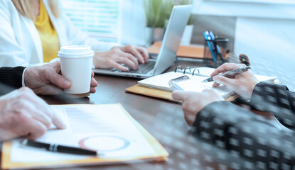 Group of three people working together; light effect