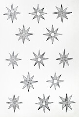Graphic drawing stars in black ink on white sheet