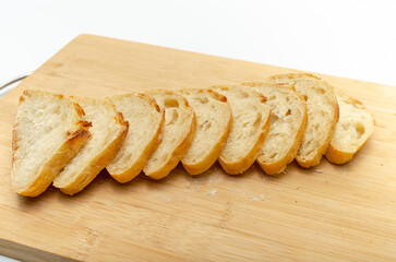 Sliced bread on a wooden board. Isolated on white background, healthy food concept.