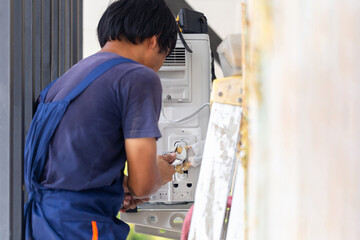 Air conditioning technicians install new air conditioners in homes, Repairman fix air conditioning...
