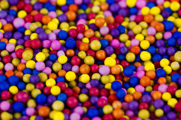 Fototapeta na wymiar Decorative polystyrene colorful balls background. Abstract bright wallpaper. Many styrofoam plastic marbles, balloons. Abstract festive backdrop.