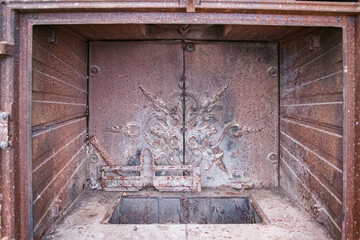 Fireplace with wood burning stove out of use and in a state of degradation, scrap. Close up