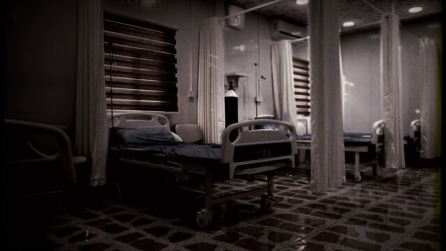 Empty Hospital Beds Old Vintage Film Texture Tracking Shot. Camera walking through some empty hospital beds, old vintage style. Tracking shot