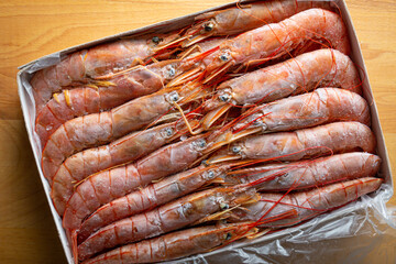 Box with frozen langoustines, shrimp
