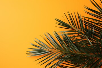 a close up of a palm tree on a yellow background with a blurry palm tree in the foreground.