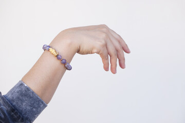 Woman's hand wears bracelet made of lucky natural stones. Concept,faith, beauty and fashion...