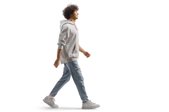 Full length portrait of a tall guy with curly hair walking