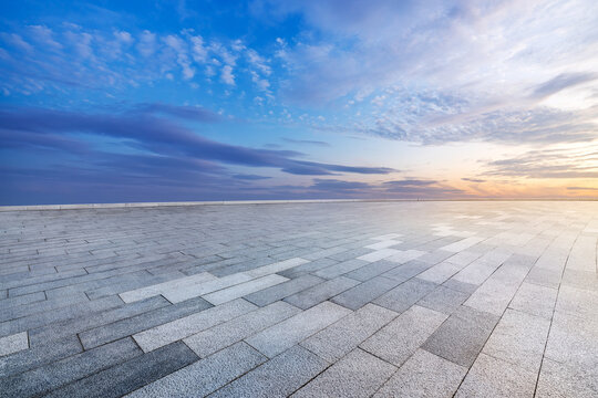 Empty brick floor and sunset clouds background