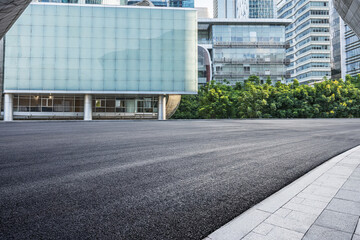 Fototapeta na wymiar Empty asphalt and city buildings landscape in summer