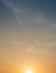 Sunset sky clouds Vertical in the evening with Orange sunlight and blue sky, Golden hour sun down background
