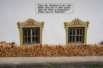Tyrol, Austria, November 4, 2023. A house saying on the facade of a typical Tyrolean house. The house saying is a personal confession in which the author communicates his attitude to life to other