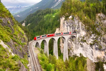 Fototapete Landwasserviadukt Swiss red train on viaduct in mountain, scenic ride