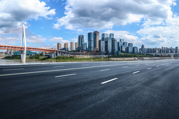 Empty asphalt road and city buildings skyline in Chongqing