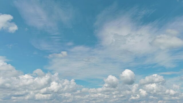 In beautiful sunny cloudscape, we fly through heavenly fluffy clouds moving blue sky