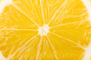 Lemon slice close-up, yellow fruit abstract background.