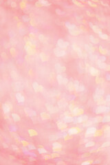 Abstract blurred vertical background with pink pastel color hearts, blurred lights as hearts bokeh,...