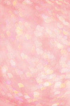 Abstract blurred vertical background with pink pastel color hearts, blurred lights as hearts bokeh, love or romance holiday fon, valentine Day festive screensaver or backdrop, color gradient