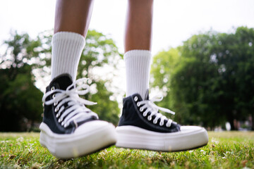Stylish black sneakers on the grass