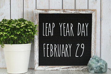 Leap Year Day, February 29, message board sign on desk - concept for event that happens every four years. - obrazy, fototapety, plakaty