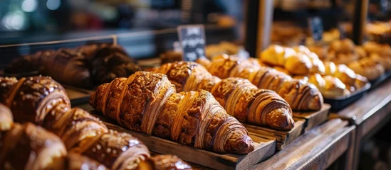 Fotobehang Image of numerous croissants and desserts in a grocery store bakery. © 2rogan