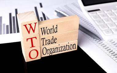 Word WTO - World Trade Organization made with wood building blocks, business concept