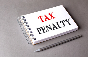 TAX PENALTY word on notebook on grey background