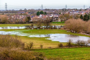 A view towards Huncote across the water meadows in Leicestershire, UK on a bright sunny day