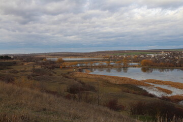 A landscape with a body of water and a city in the distance