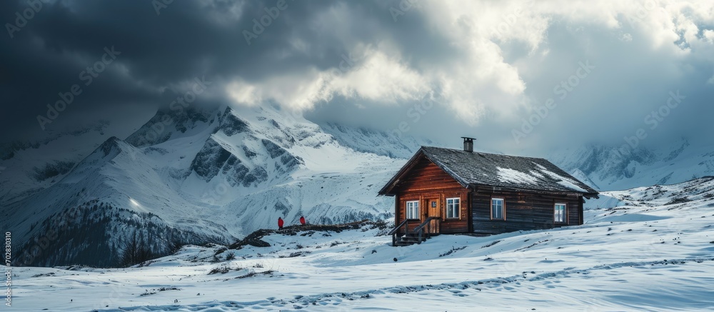Poster minimalistic winter landscape with wooden cabin and tourist in red jacket in snowy mountains cloudy 