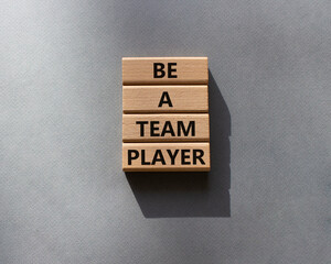 Be a team player symbol. Concept words Be a team player on wooden blocks. Beautiful grey background. Business and Be a team player concept. Copy space