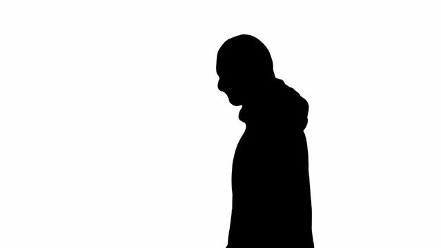 Black silhouette of thief on isolated white background. Male robber in hoodie and balaclava walking, preparing to commit a crime. Side view.