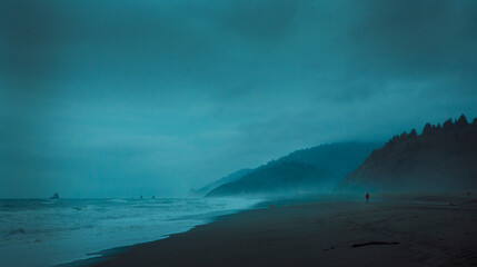 Lonely runner in a stormy and misty beach