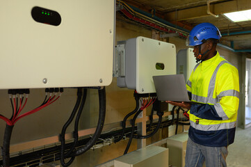 engineering technician Setting up the solar panel inverter in the electrical room Service engineer...