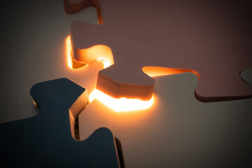 Concept for mistery stuff. Under exposure view of jigsaw puzzle with a glowing light. After some edits. © Figan