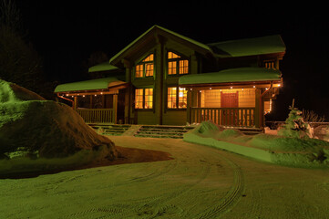 Wooden house with beautiful New Year's lighting at night