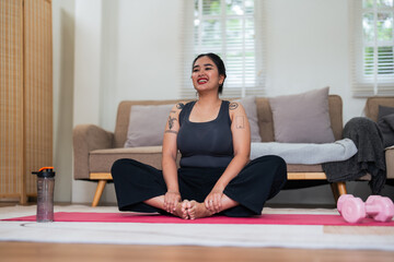 Asian overweight woman doing stretching exercise at home on fitness, Stretching training workout on yoga mat at home for good health and body shape