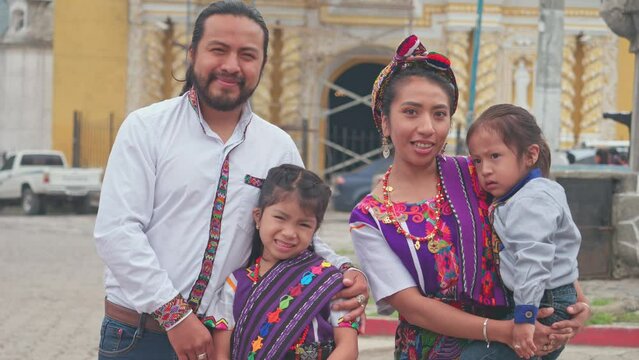 Portrait of a beautiful indigenous family, wearing elegant and beautiful clothes, looking at the camera for a family portrait.